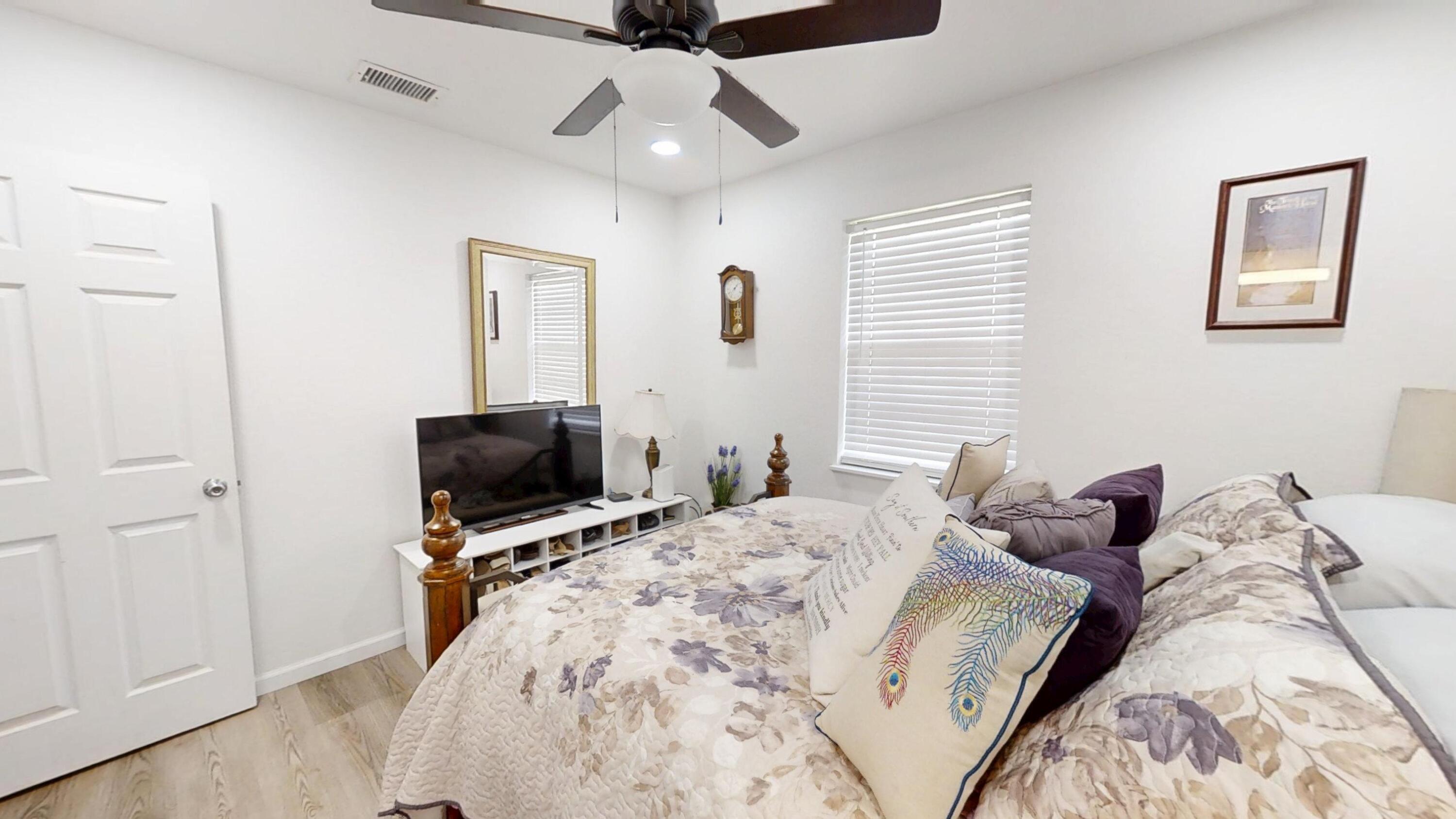 1202 Sunshine Drive Crestview, FL 32539 - Photo 27 of 38 a bedroom with a bed and a flat screen tv