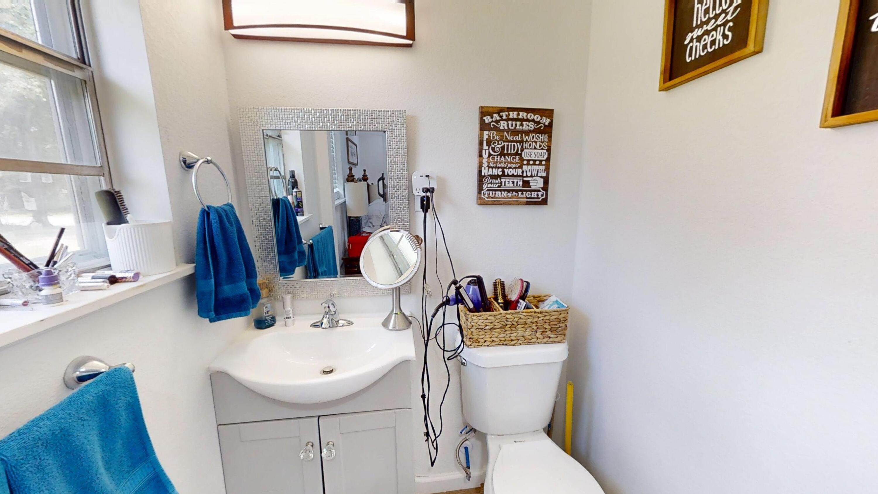 1202 Sunshine Drive Crestview, FL 32539 - Photo 31 of 38 a bathroom with a toilet sink and mirror