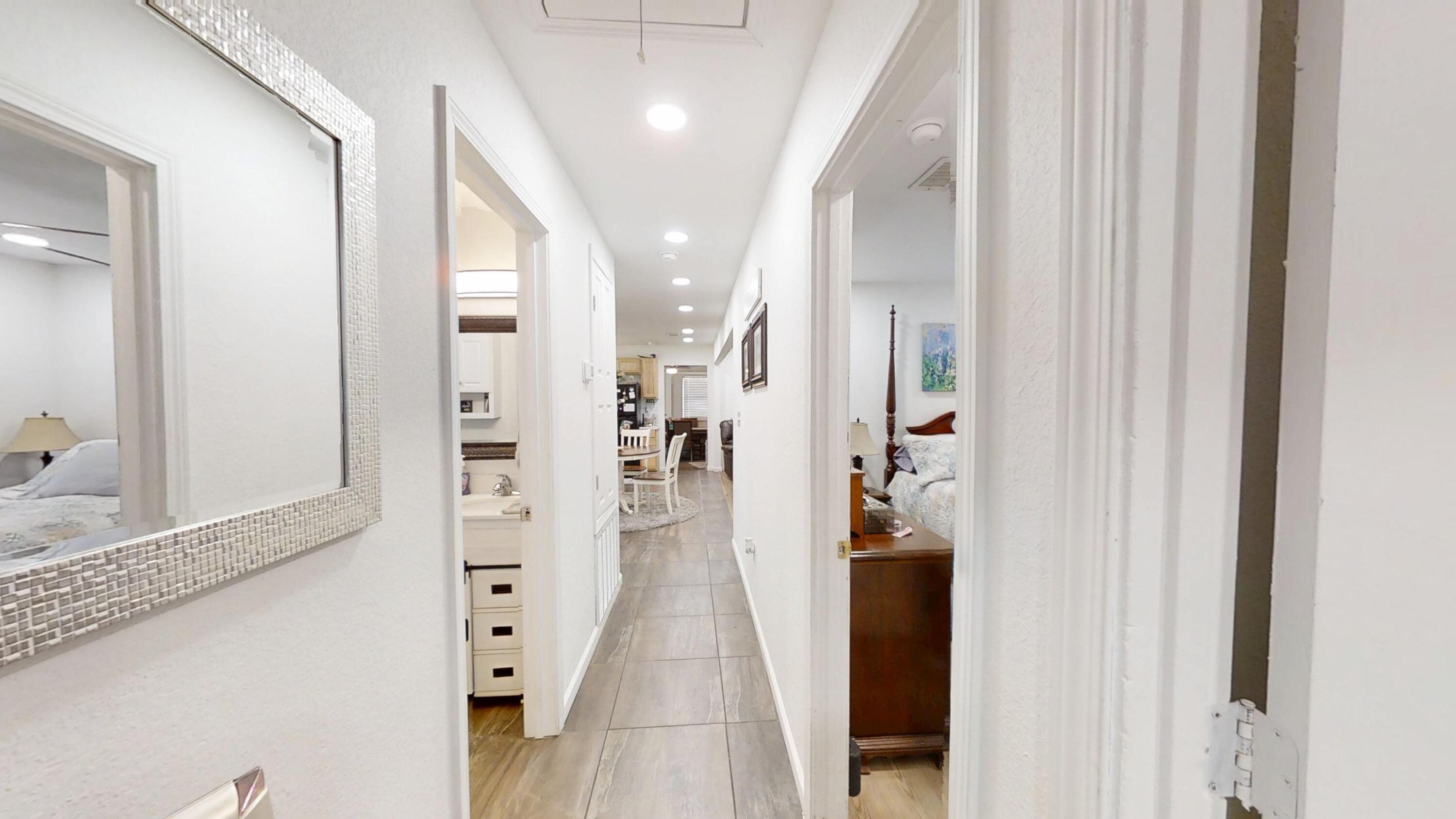 1202 Sunshine Drive Crestview, FL 32539 - Photo 32 of 38 a view of a hallway with wooden floor and windows