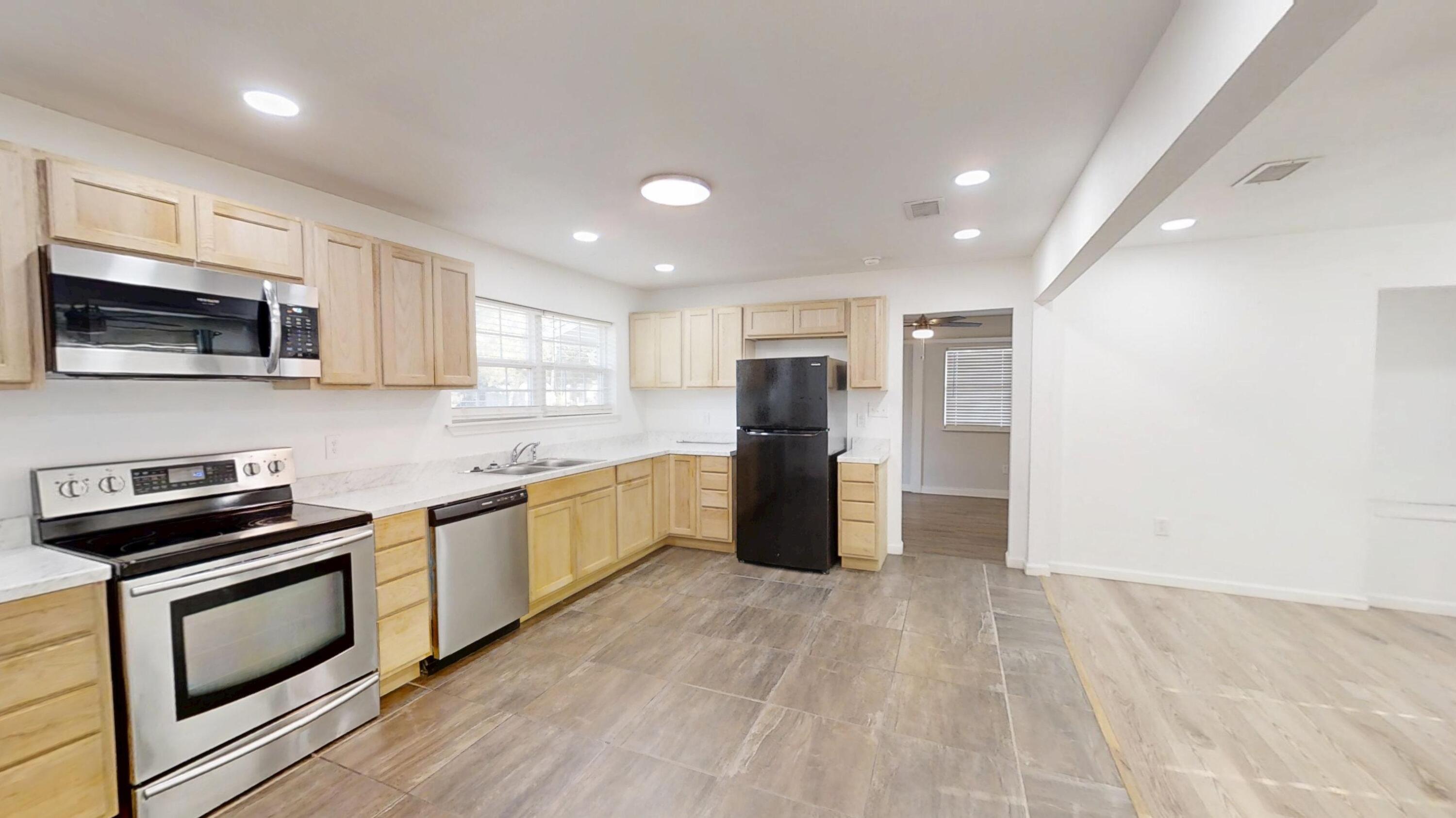 1202 Sunshine Drive Crestview, FL 32539 - Photo 4 of 38 a kitchen with stainless steel appliances granite countertop a refrigerator a stove top oven a sink and dishwasher