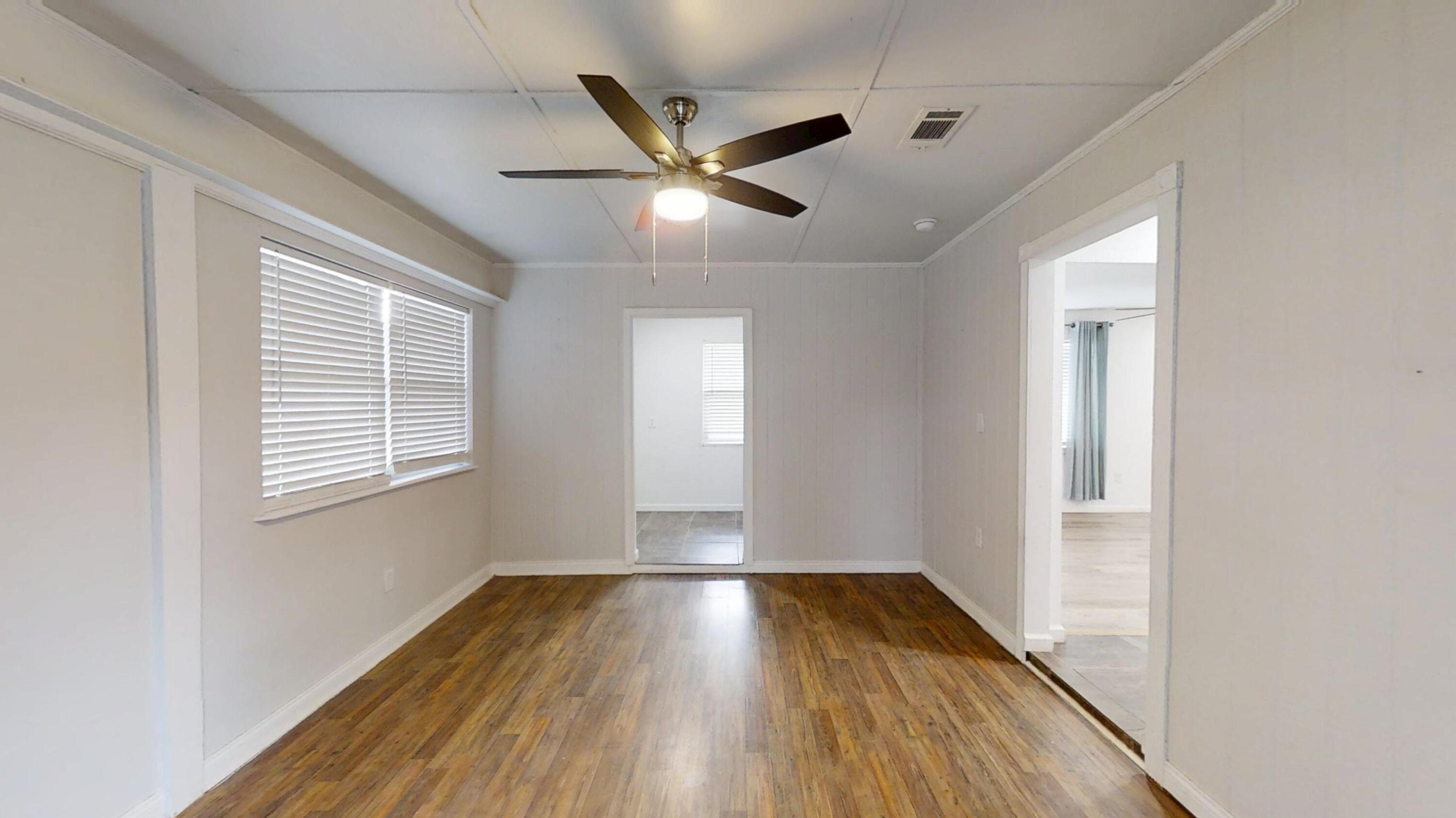 1202 Sunshine Drive Crestview, FL 32539 - Photo 7 of 38 a view of empty room with wooden floor and fan