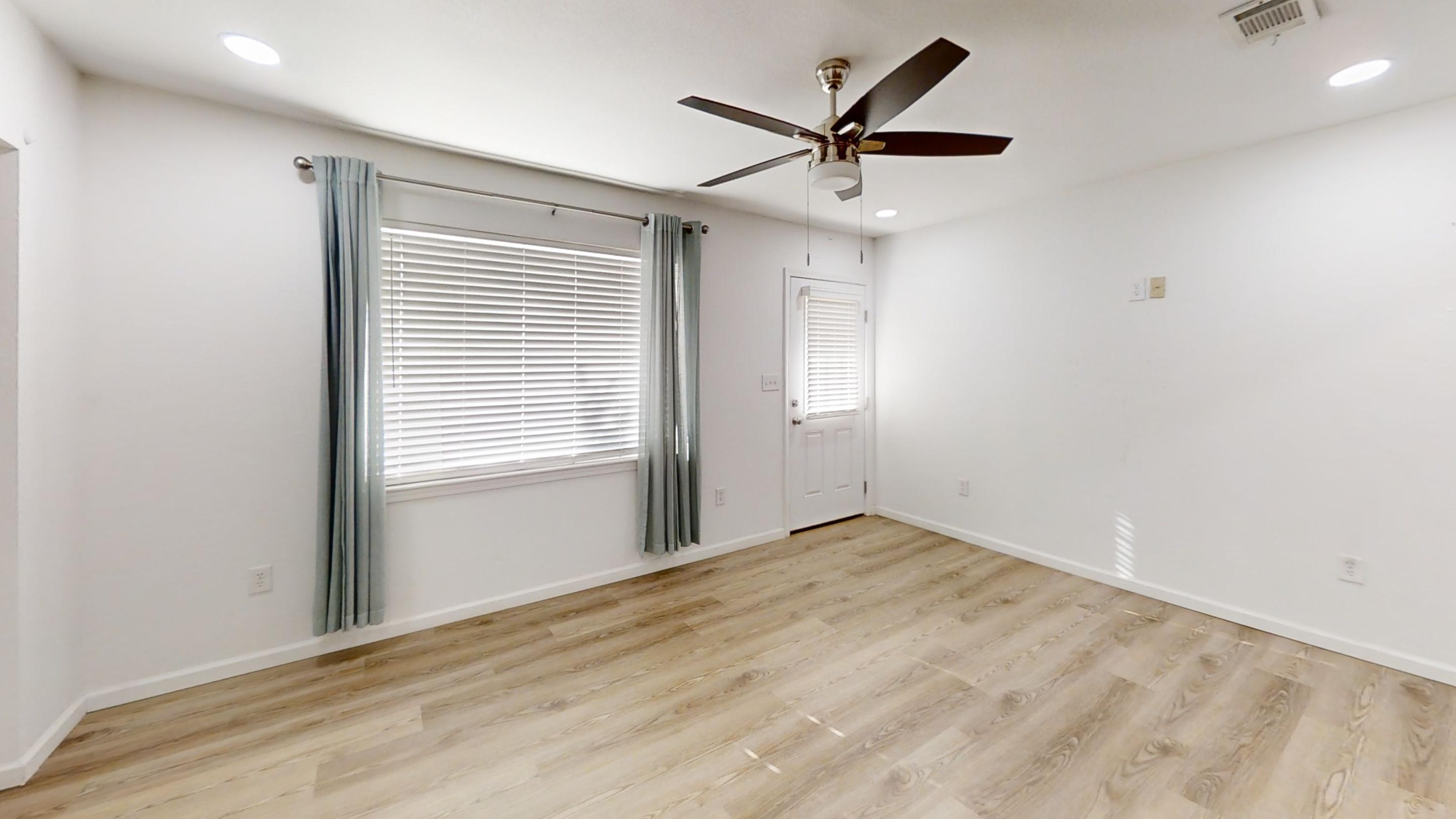 1202 Sunshine Drive Crestview, FL 32539 - Photo 10 of 38 wooden floor in an empty room with a window