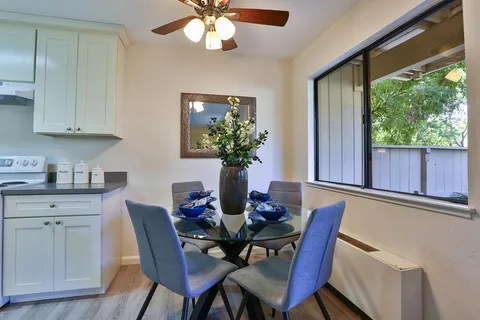 a view of a dining room with furniture and a window