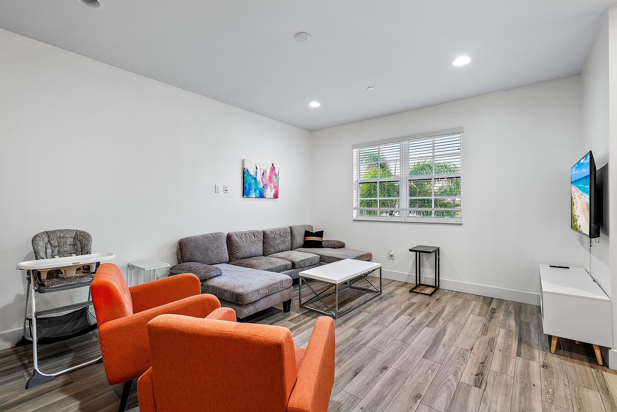 3770 County Line Road, Unit C6 Tequesta, FL 33469 - Photo 25 of 33 a living room with furniture and a wooden floor
