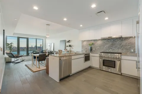 a open kitchen with a stove top oven and cabinets