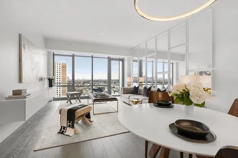 a living room with furniture a rug and white walls
