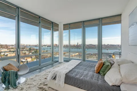 a bedroom with a large bed and a large window