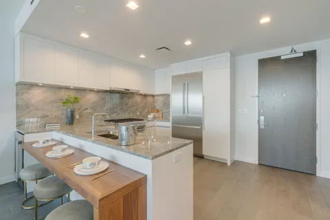 a kitchen that has a table and chairs in it