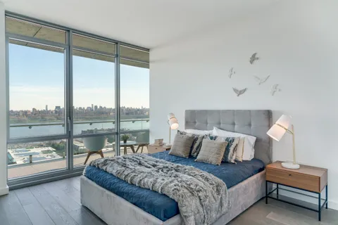 a bedroom with a large bed and a large window