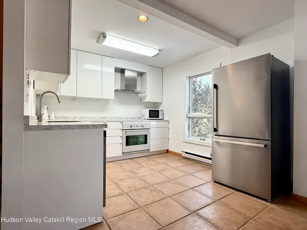 a kitchen with cabinets appliances and a sink