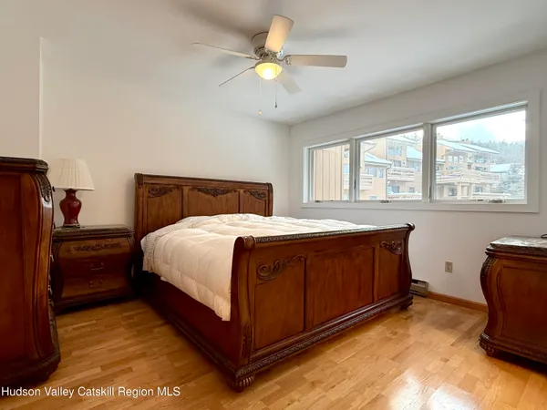 a bedroom with a bed and a large window