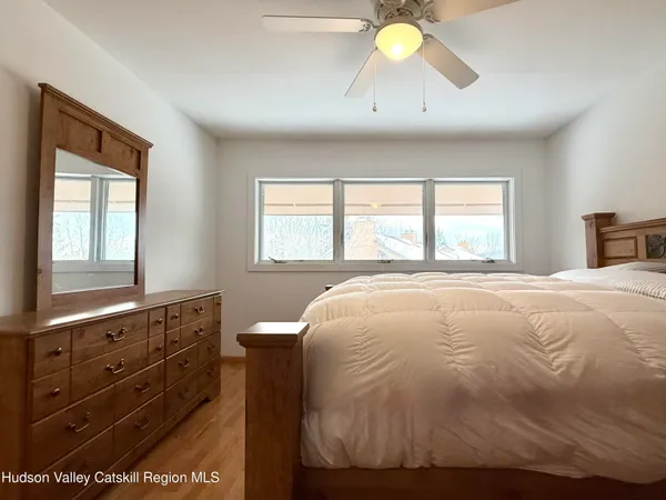 a bedroom with a bed and a ceiling fan