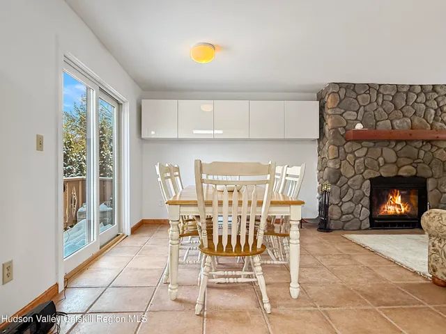 a view of a dining room with furniture and a potted plant