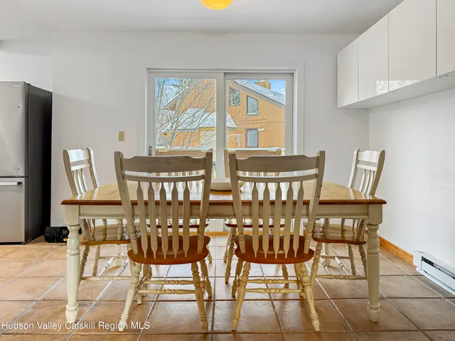 a view of a dining room with furniture and a window