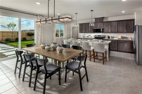 a kitchen with kitchen island a table and chairs in it