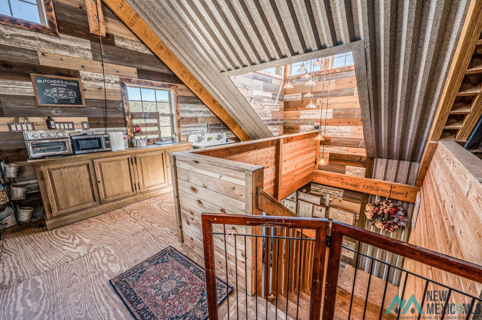 398 Pine Road Capitan, NM 88316 - Photo 27 of 68 Stairs with wood walls and lofted ceiling