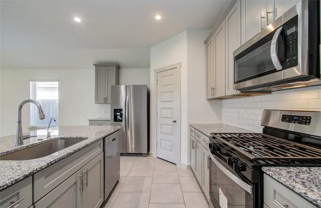 a large kitchen with a lot of counter space and a sink