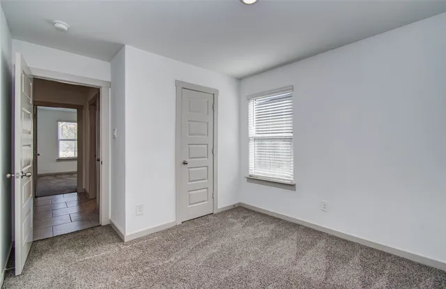 a bathroom with a granite countertop toilet sink and mirror