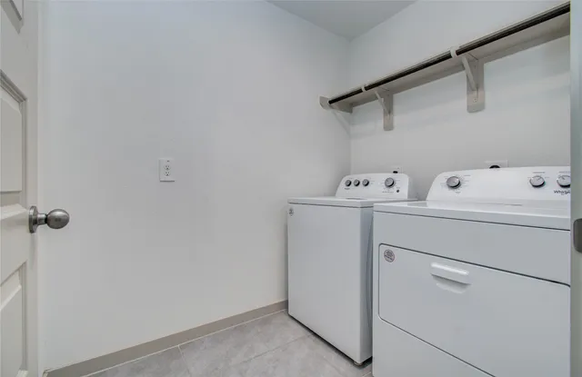 a view of a yard in front of a house with large tree