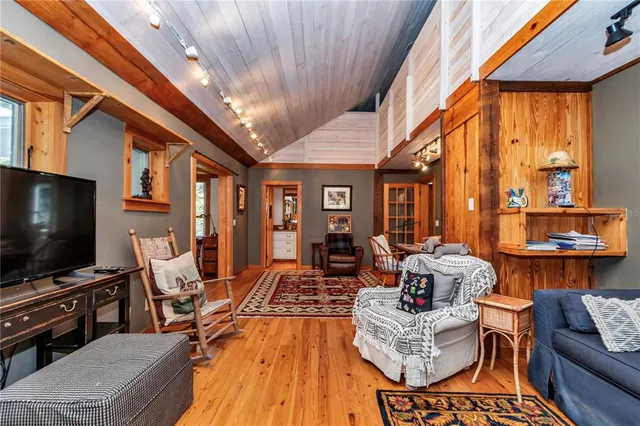 a living room with furniture a dining table and a rug