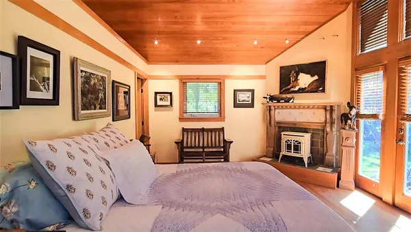 a bathroom with a granite countertop tub a sink and a window