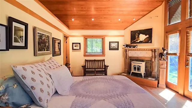 a bathroom with a granite countertop tub a sink and a window