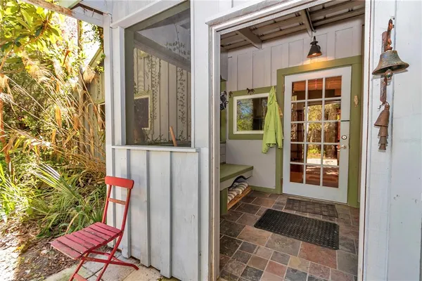 a room with stainless steel appliances lots of wooden furniture