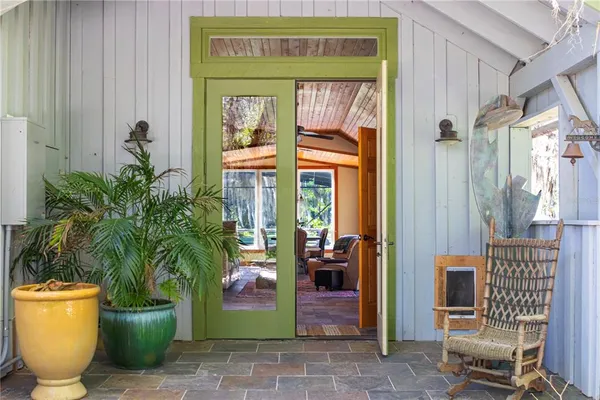 a view of a swimming pool with a couches and table in the patio