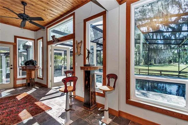 a living room with furniture a ceiling fan and a rug