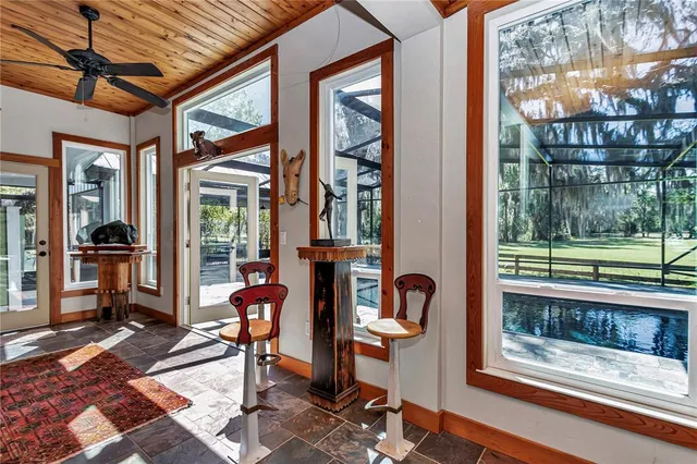 a living room with furniture a ceiling fan and a rug