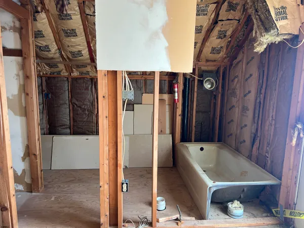 a bathroom with a tub and shower