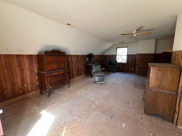 a living room with furniture a ceiling fan and a rug
