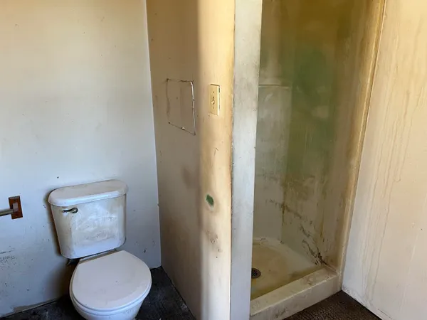 a white toilet sitting next to a bathroom sink