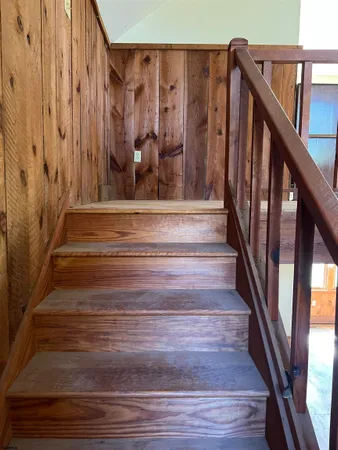 a view of staircase with wooden floor and stairs