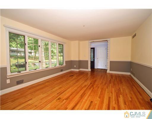 9 Greenwich Road Edison, NJ 08820 - Photo 4 of 25 a view of empty room with wooden floor and fan