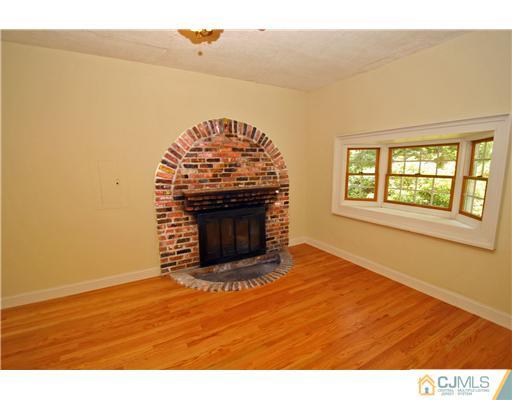 9 Greenwich Road Edison, NJ 08820 - Photo 6 of 25 a view of empty room with wooden floor and fireplace