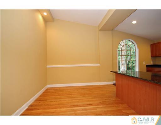 9 Greenwich Road Edison, NJ 08820 - Photo 10 of 25 a view of an empty room with wooden floor and a window