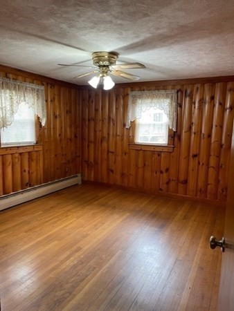 5 Kitchener Road Sterling, MA 01564 - Photo 12 of 29 a view of an empty room with a window and wooden floor