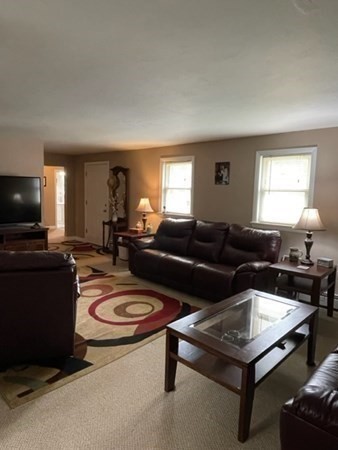 5 Kitchener Road Sterling, MA 01564 - Photo 17 of 29 a living room with furniture and a flat screen tv