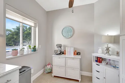 a view of a dining room with furniture and a chandelier