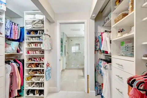 a bathroom with a granite countertop sink a large mirror and shower