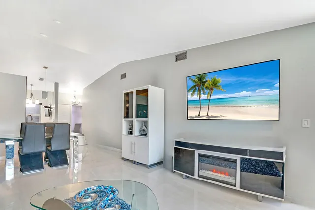 a view of a bedroom with wooden floor and window