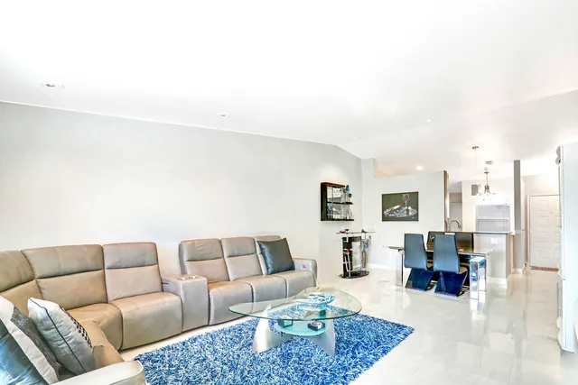 a bathroom with a sink a toilet a mirror and shower