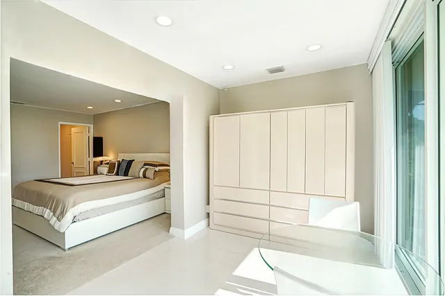 a living room with furniture ceiling fan and a flat screen tv