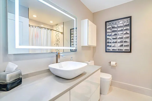 a living room with kitchen island furniture and a chandelier