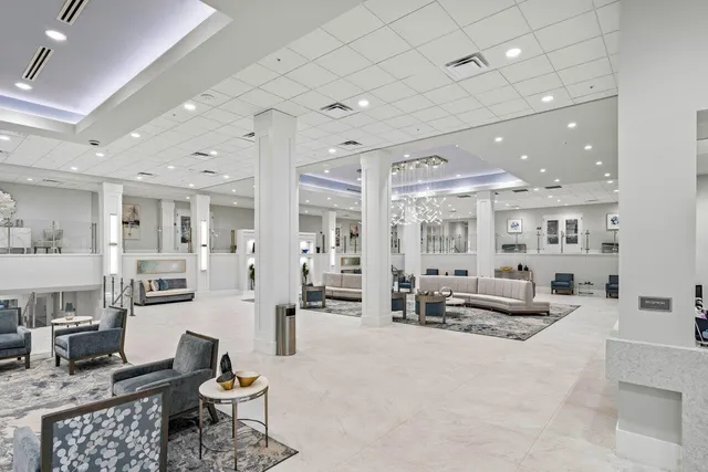 a living room with furniture a table and chairs