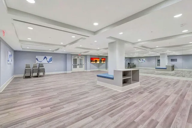 a view of a tennis ground with large trees