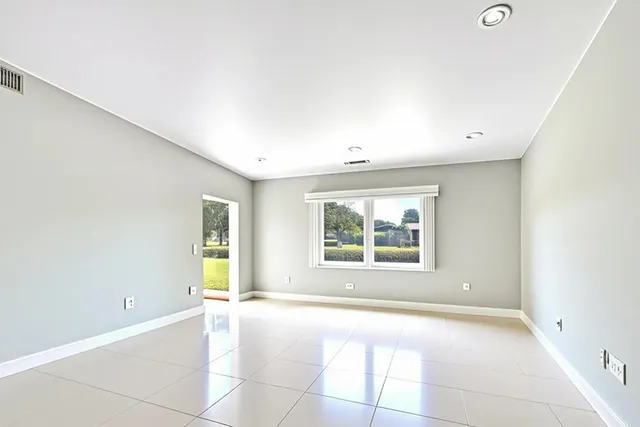 a view of a dining room with furniture and a potted plant