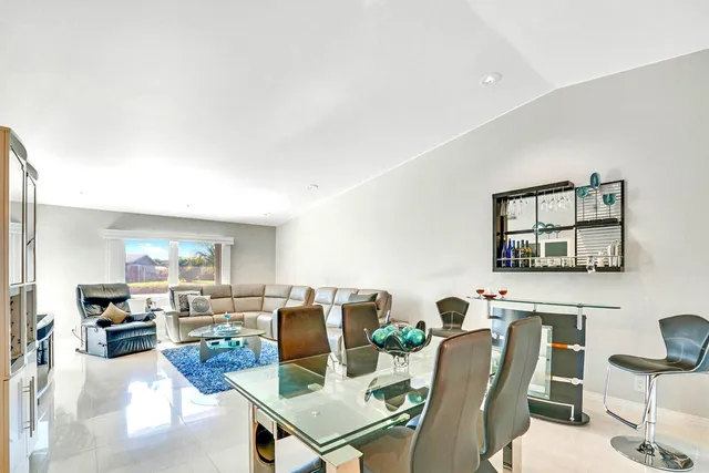 a living room with furniture a dining table and kitchen view