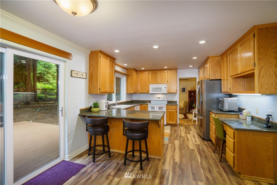 1230 Cedar Circle Langley, WA 98260 - Photo 13 of 39 a kitchen with stainless steel appliances granite countertop sink refrigerator and wooden floor